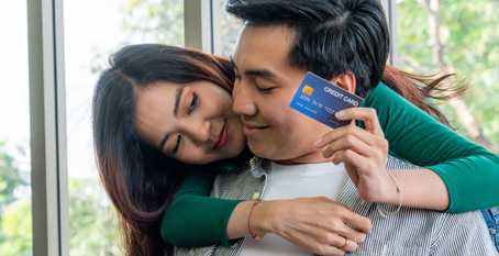 young couple with bank card